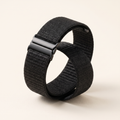 Longetive replacement strap in black, coiled on studio background